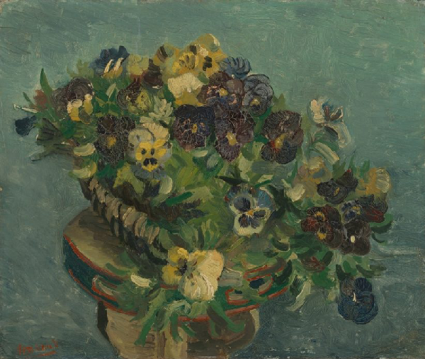 A bouquet of flowers in varying colours of purple and yellow in a vase with some green folage