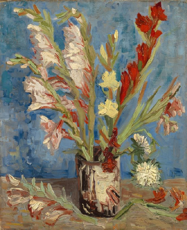 Tall flowers in red and white in a cylinder vase